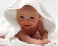 baby hiding under a towel