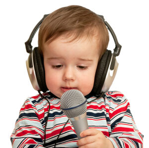 Toddler with headphones and a microphone