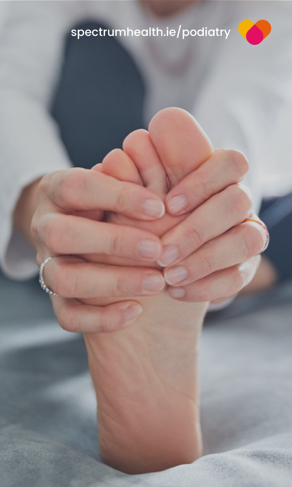 Woman holding a painful foot