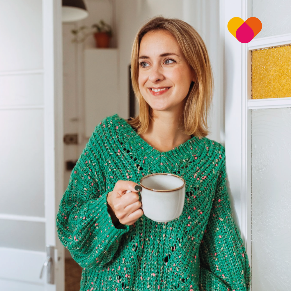 Smiling happy woman drinking coffee