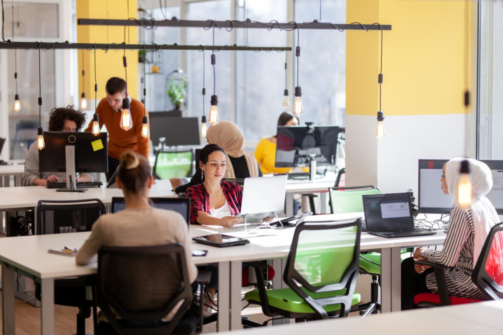 A bright office with multiple people working