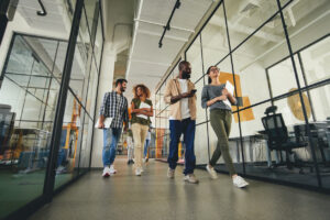 Group of people walking through the office talking