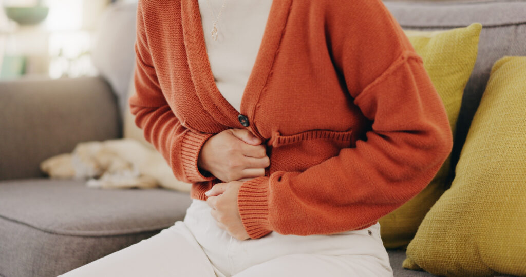 Female with hands on tummy due to bloated stomach