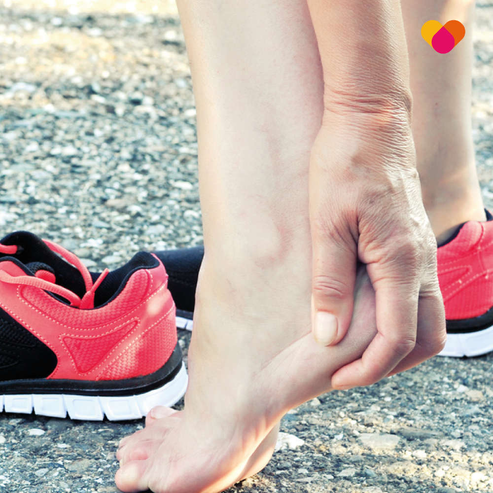 Female runner suffering from severs disease in the heel of her foot