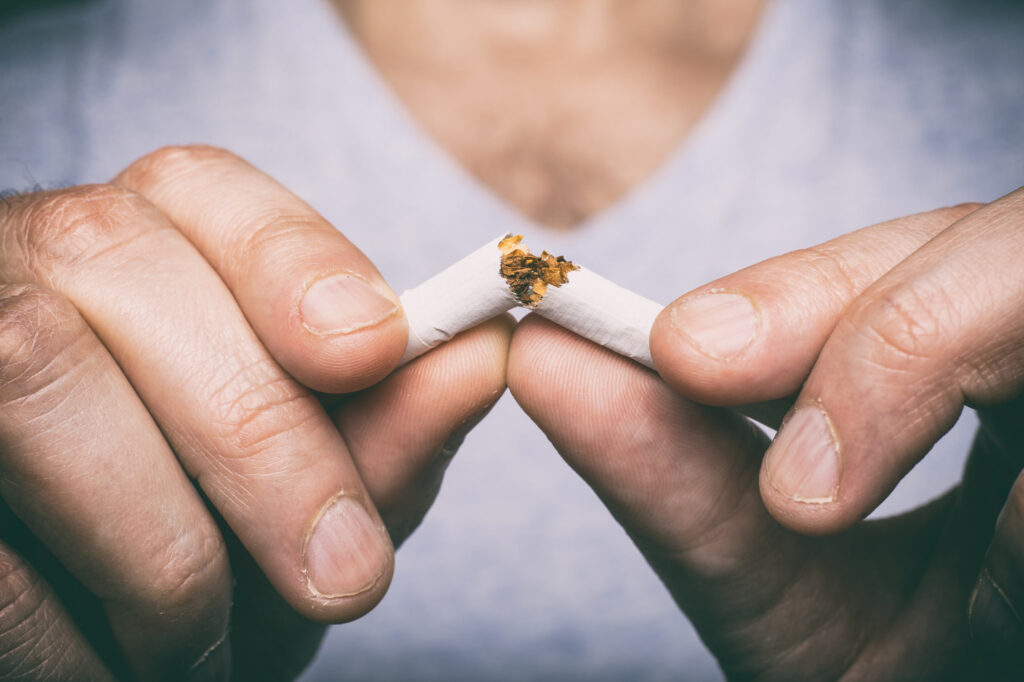 Man breaking a smoke in half