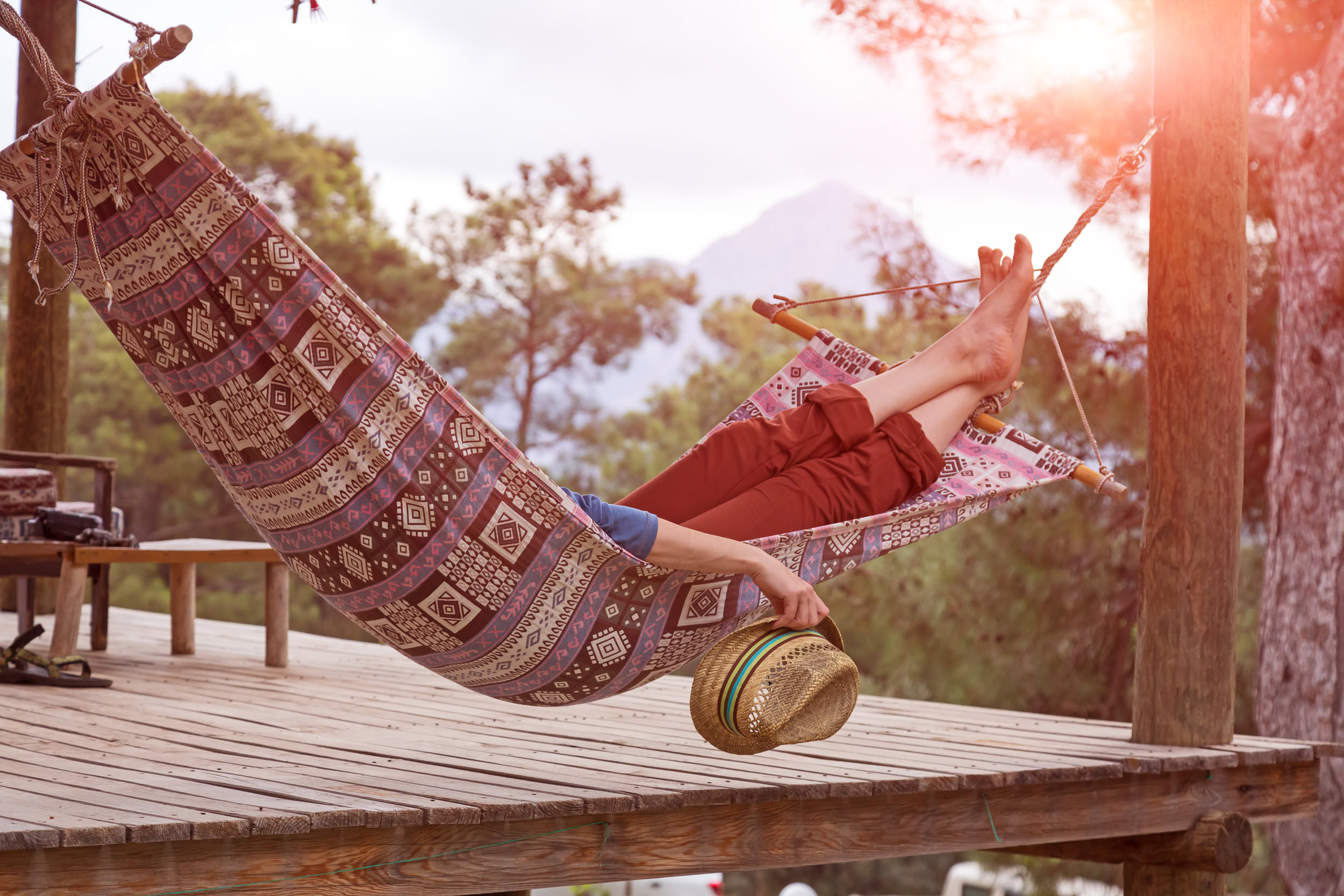 Person in a hammock relaxing barefoot