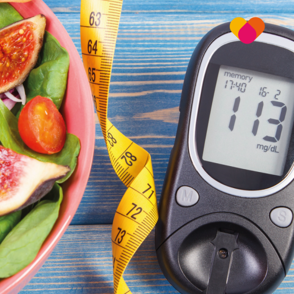 Diabetes test machine with measuring tape and healthy food